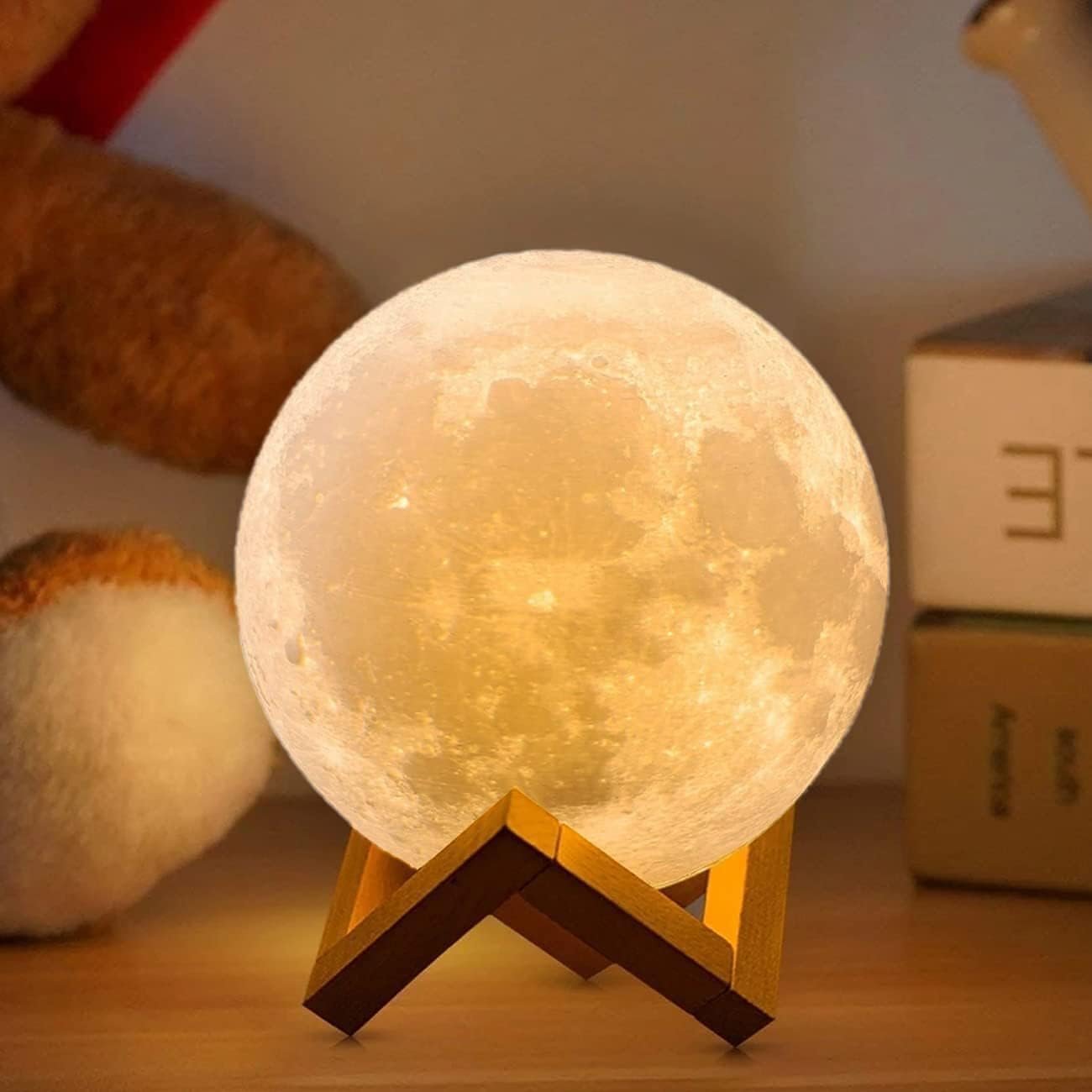 Glowing 3D moon lamp on a wooden stand