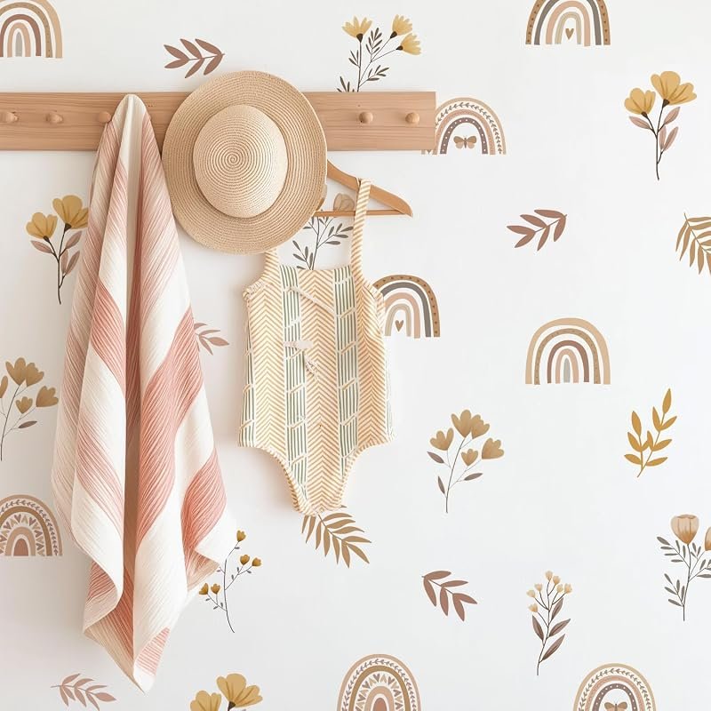 Boho rainbow and wildflower wall decals in earthy pink, mustard and sage tones arranged on a nursery wall