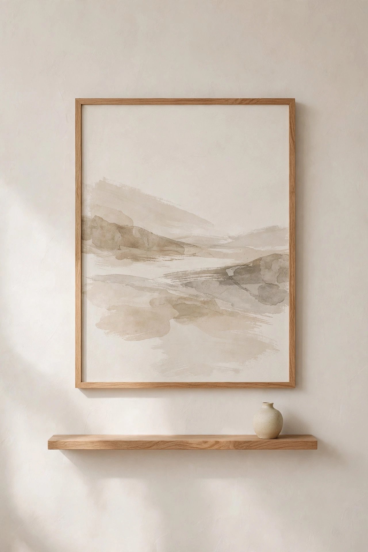 Single framed abstract landscape print in thin oak frame on an empty wall in a Japandi nursery