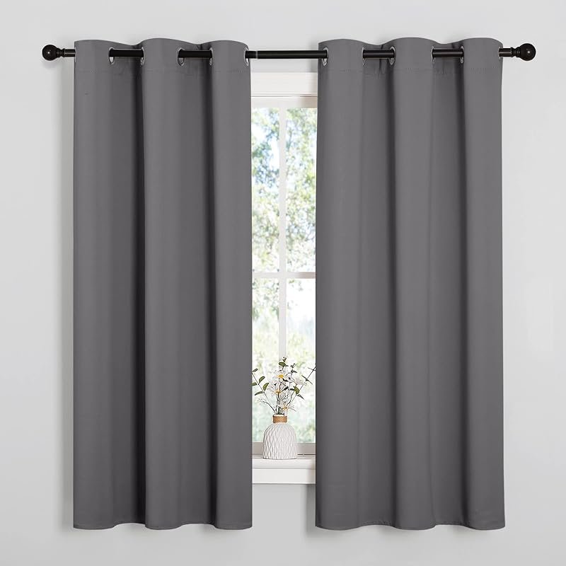 NICETOWN grey grommet blackout curtain panels hung on a rod