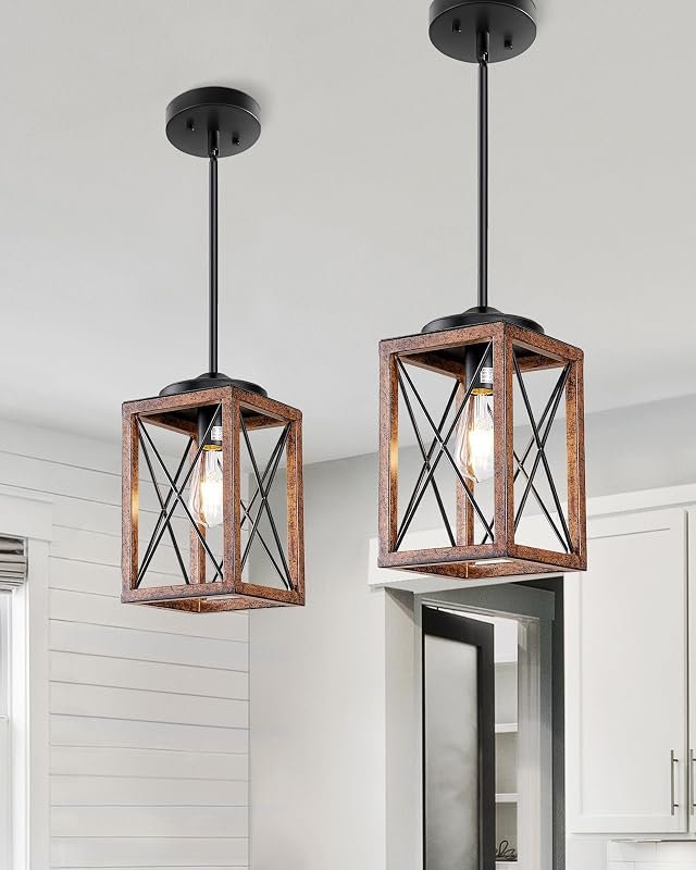 Two farmhouse wood-and-metal cage pendant lights hanging over a kitchen island