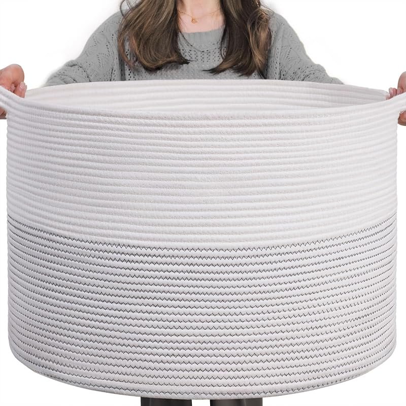 Large white woven cotton rope storage basket held up to show its size
